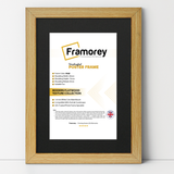 Pine Picture Frame with Black Mount leaning with the wall on a wooden floor with some detail on its measurement.