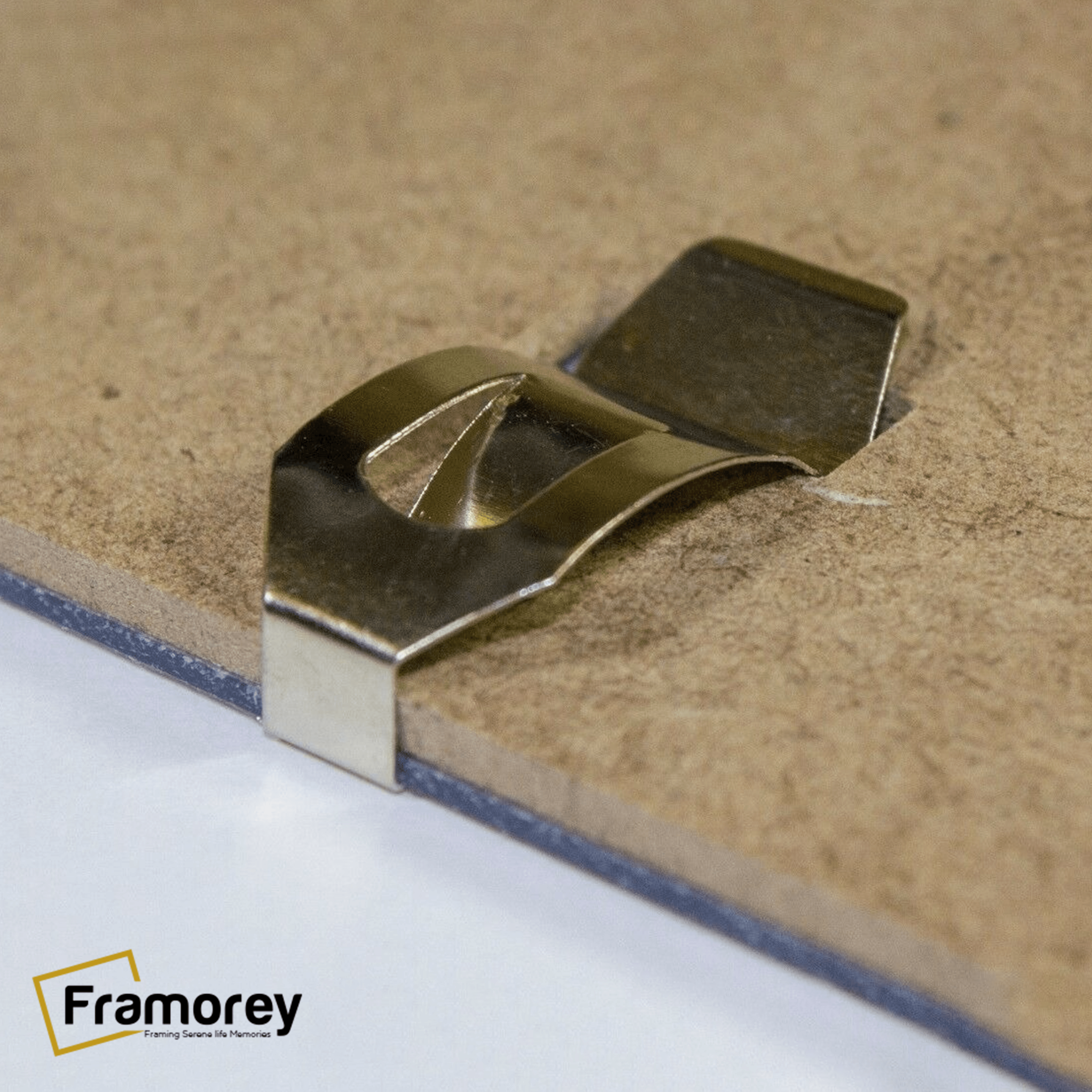 A clip of a Picture Frames is shown in this picture on a wooden board.