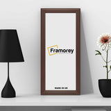 Antique Style Panoramic Mahogany Photo Frame leaning with the wall and a back lamp and a flower pot  placed around it.