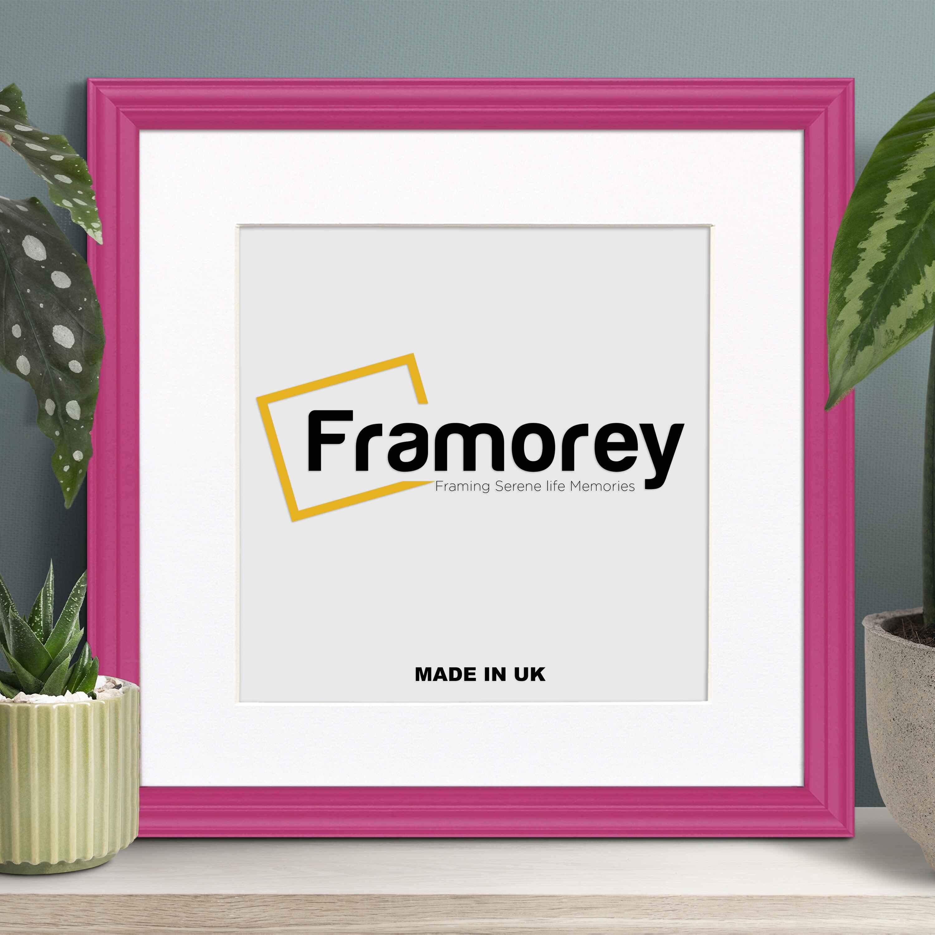 Antique Style Square Pink Poster Frame with White Mount with some decorative items place near it.