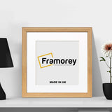 Antique Style Square Size Oak Photo Frame leaning with the wall and a lamp and a black flower with pot placed around it.