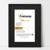 thin matt black picture frame with black mount shown from front view on a plain white surface standing with a wall