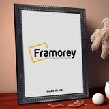 Black Square Style Poster Frame front view placed on a red carpet leaning with the wall.