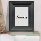 Black picture frame shown from front view on a table standing with a wall