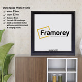 Square Size Black Oslo Poster Frames on a wooden table standing with the wall with some detail on its measurement.