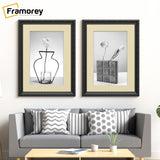 Two Black Shabby Chic Poster Frames With Ivory mount Hanging on a Wall Over a Couch