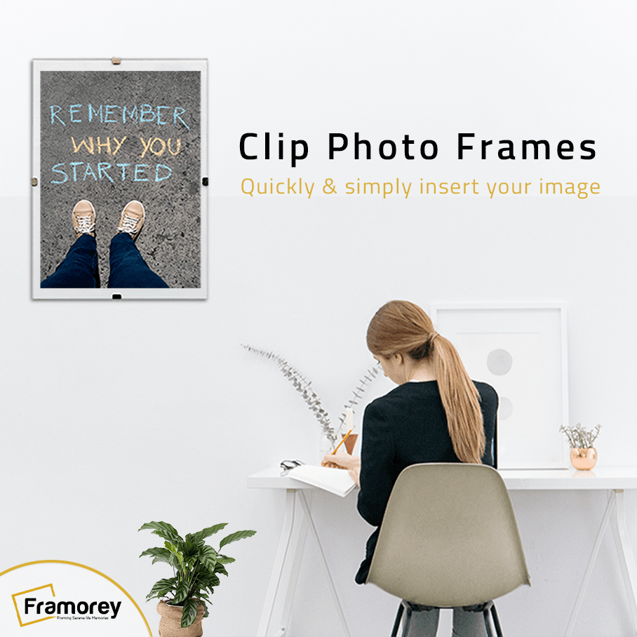 Clip Photo Frames Quickly and Simply insert your image and a a frame is hanging on a wall with some shown clips that attaches a picture frame with the back board and a lady is sitting on a chair and writing something on a note book.