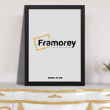 Flat black photo print frame placed on wooden table