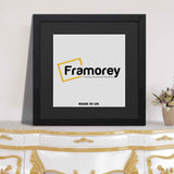 Flat square black photo frame with black mount placed on a table for home decor