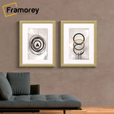 Two Gold glitter Sparkle poster frames With White Mount Hanged on a wall.