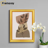 Gold Picture Frames Handmade Wooden Effect  hangs on a wall with a white flower with pot place on its right.