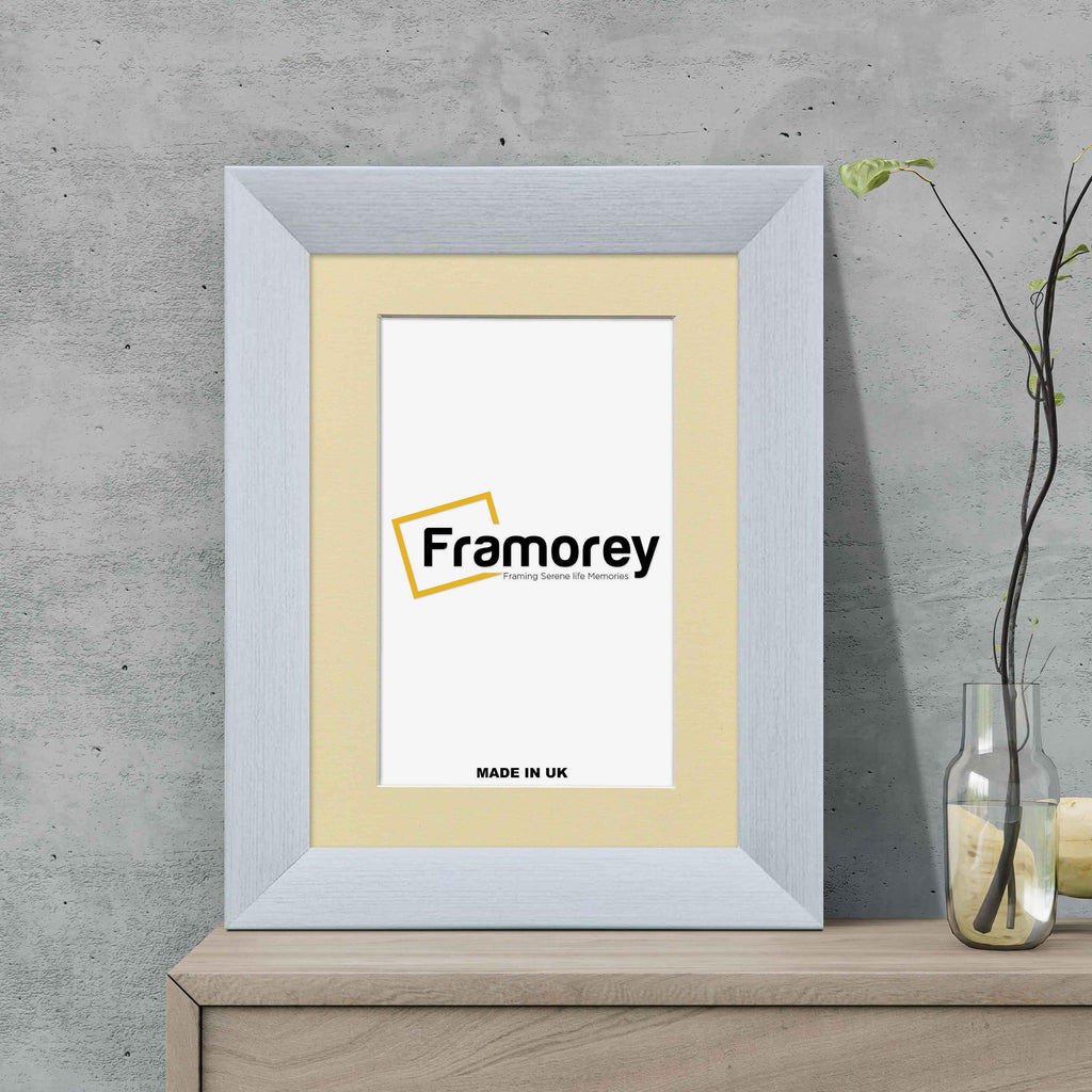 Limed White Picture Frame With Ivory Mount on a wooden drawer standing with the wall.
