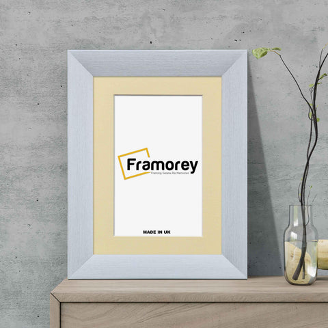 Limed White Picture Frame With Ivory Mount on a wooden drawer standing with the wall.