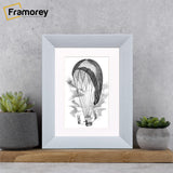Limed White Picture Frame With White Mount on a wooden slab leaning with the wall.