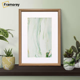Thin Oak Photo Frame With White Mount on a black wood standing with the wall .