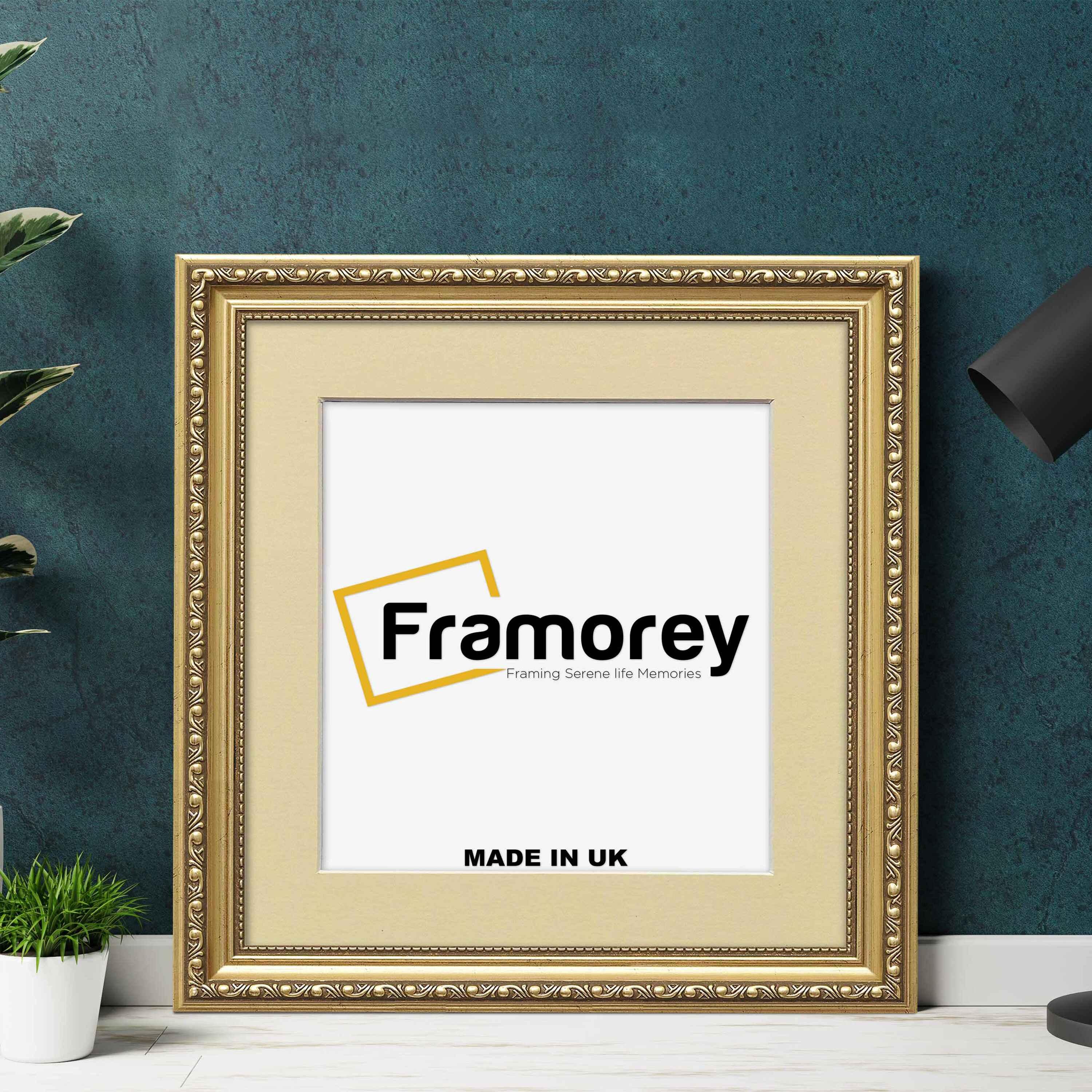 Square gold ivory mount shabby picture frame lean with the wall and a black lamp placed near it.