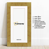 Gold panoramic photo print frame with white mount lean with the wall and details.