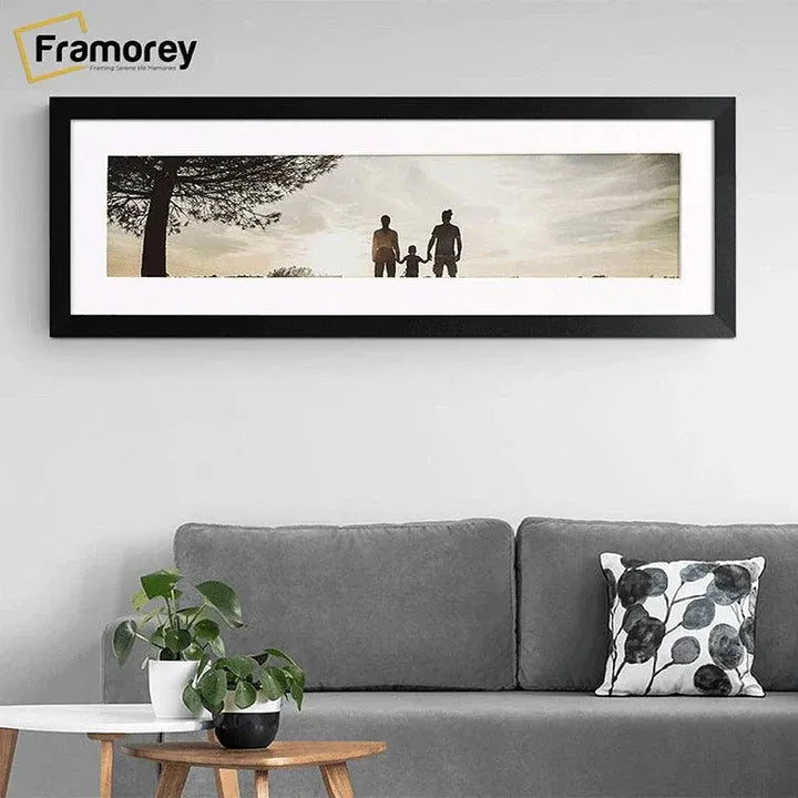 Panoramic Size Matt Black With White Mount Mount in a Landscape Direction hanging on a wall just over the couch.