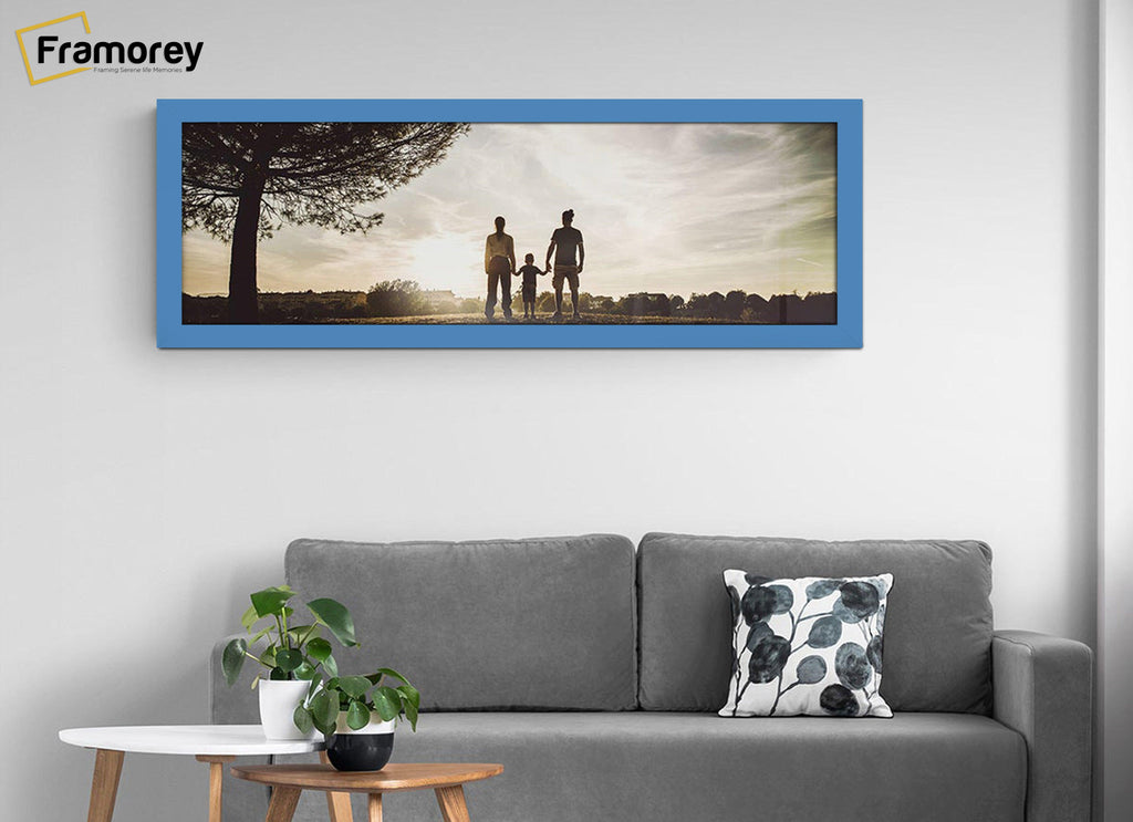 Panoramic Size Blue Picture Frames hanging on a wall over the couch.