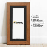 Panoramic Size Walnut Picture Frames Handmade Wooden Poster Frames with black mount leaning with the wall on a wooden floor and some detail on its measurement.