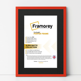 thin matt red picture frame with black mount shown from front view on a plain white surface standing with a wall