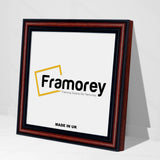 Side view of a Square Size Walnut Photo Frames standing with the wall on a flat surface.