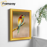Side view of a Gold Photo Frames Handmade Wooden Effect hangs on a wall with a bird picture inside it.
