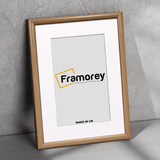 Side view of a Oak Minimalist Photo Frame With White Mount leaning with the wall 
