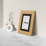 Side view of a Oak Picture Frame with Black mount Poster Frame with a framorey logo inside the frame.