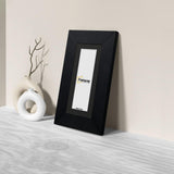 Side view of a Panoramic Black Photo Print Frame with Black Mount is leaning with the wall on a wooden surface.