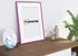 Side view of a Thin Pink Photo Frame With White Mount Flat Wooden Effect Maxi Art leaning with a wall on a wooden table and a Framorey logo place inside the frame.