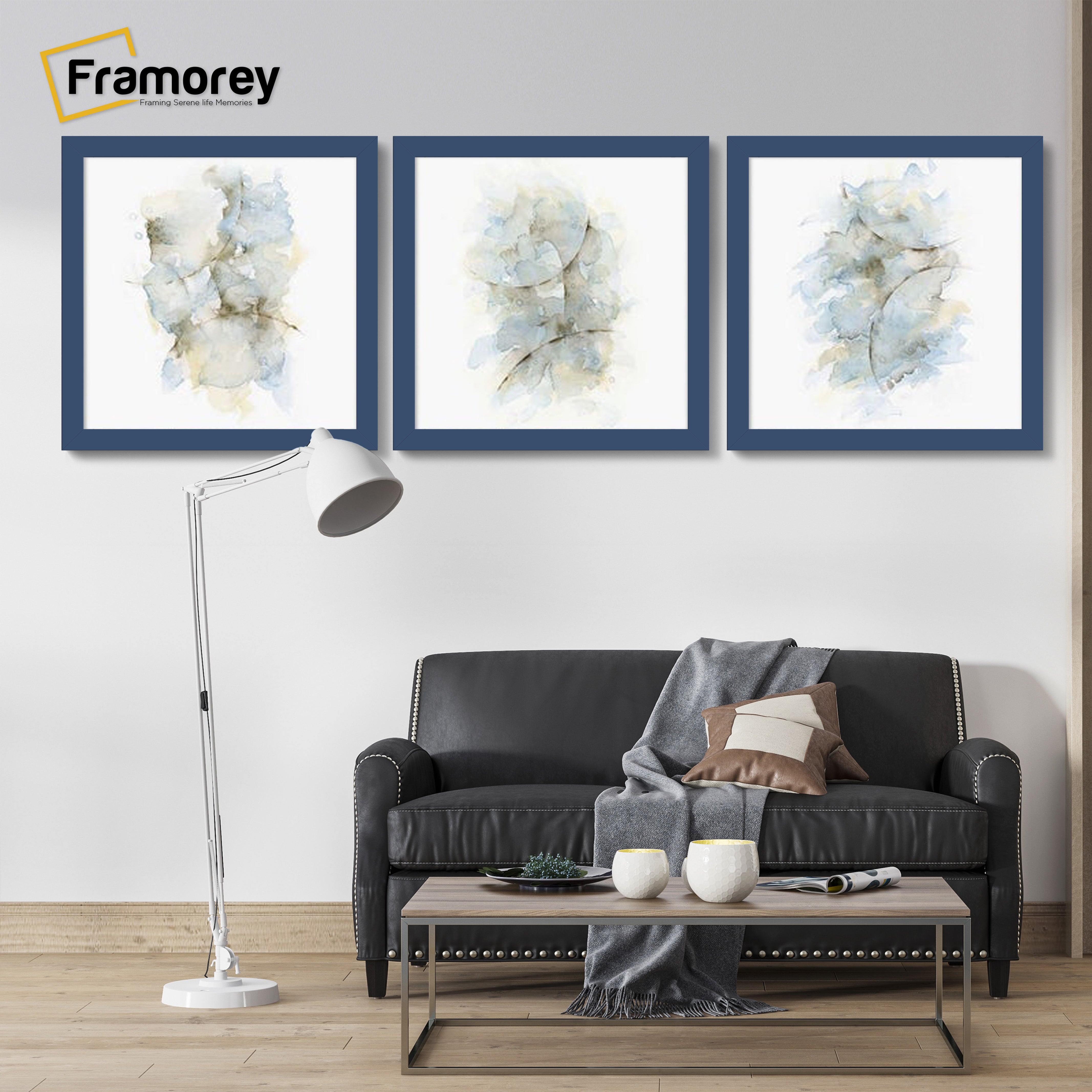 Three Square Size Blue Poster Frame hanged on a wall over a couch.