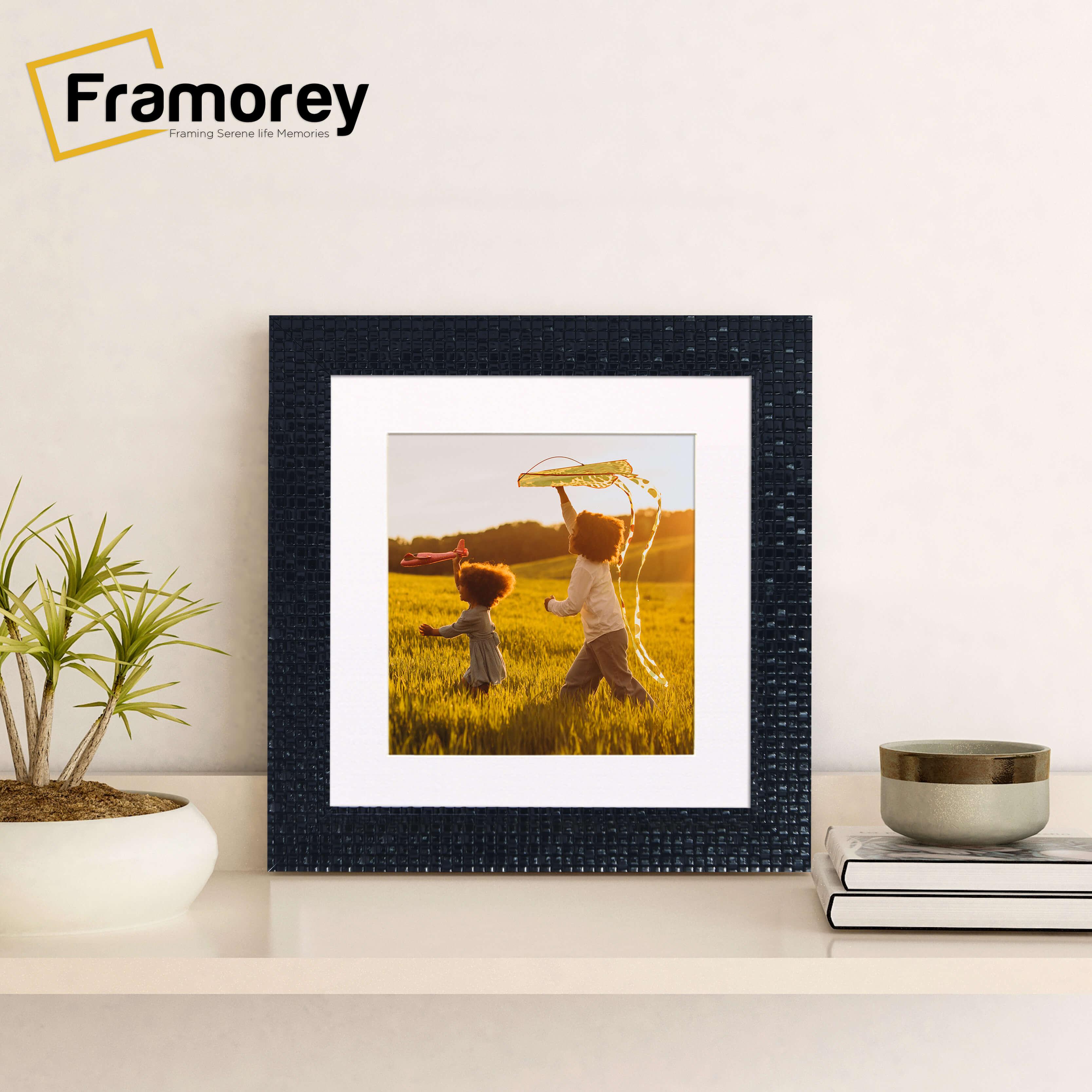 Square Black Picture Frame Rockstar Style With White Mount on a wooden table standing with the wall.