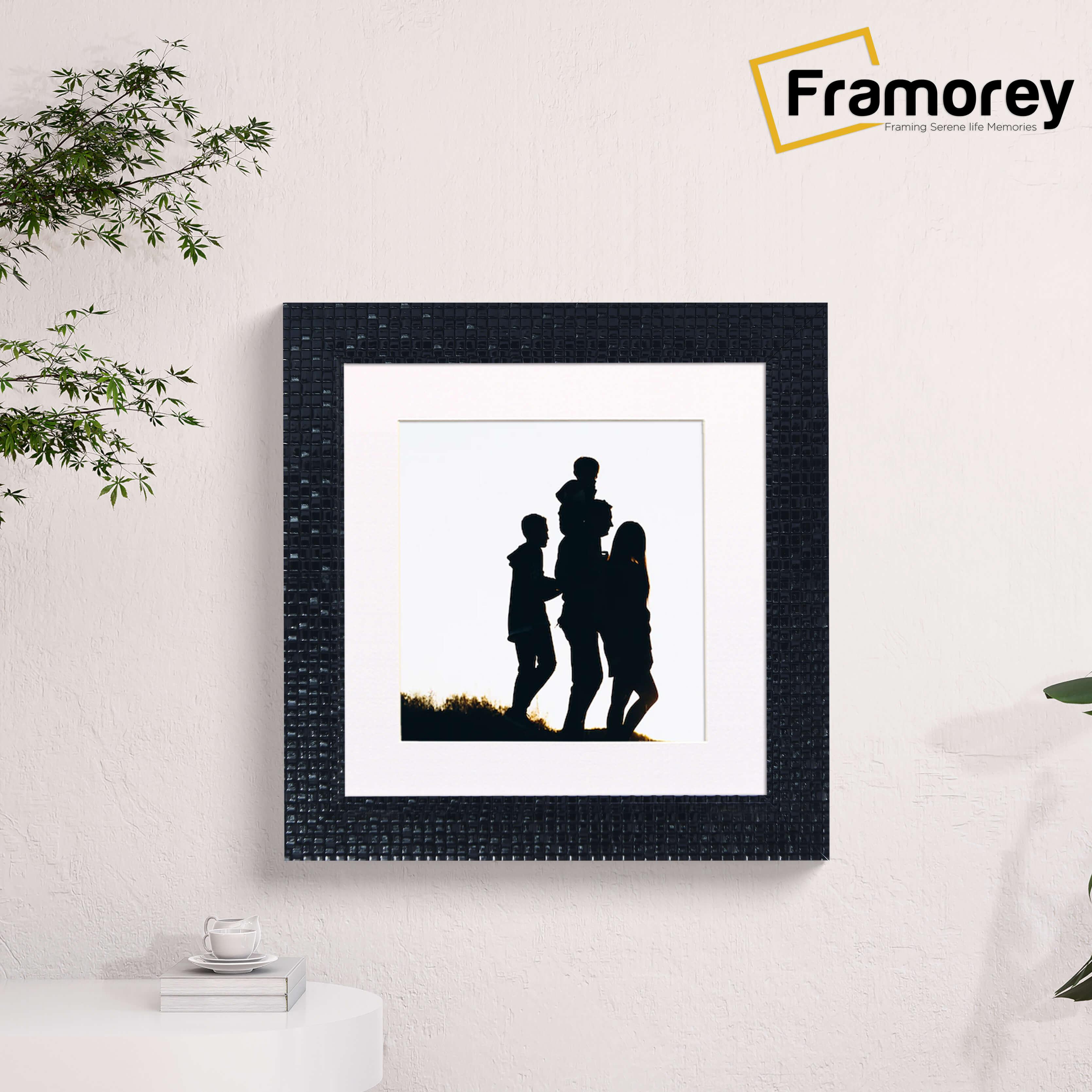 Square Black Photo Frame Rockstar Style With White Mount is hanging on a wall.