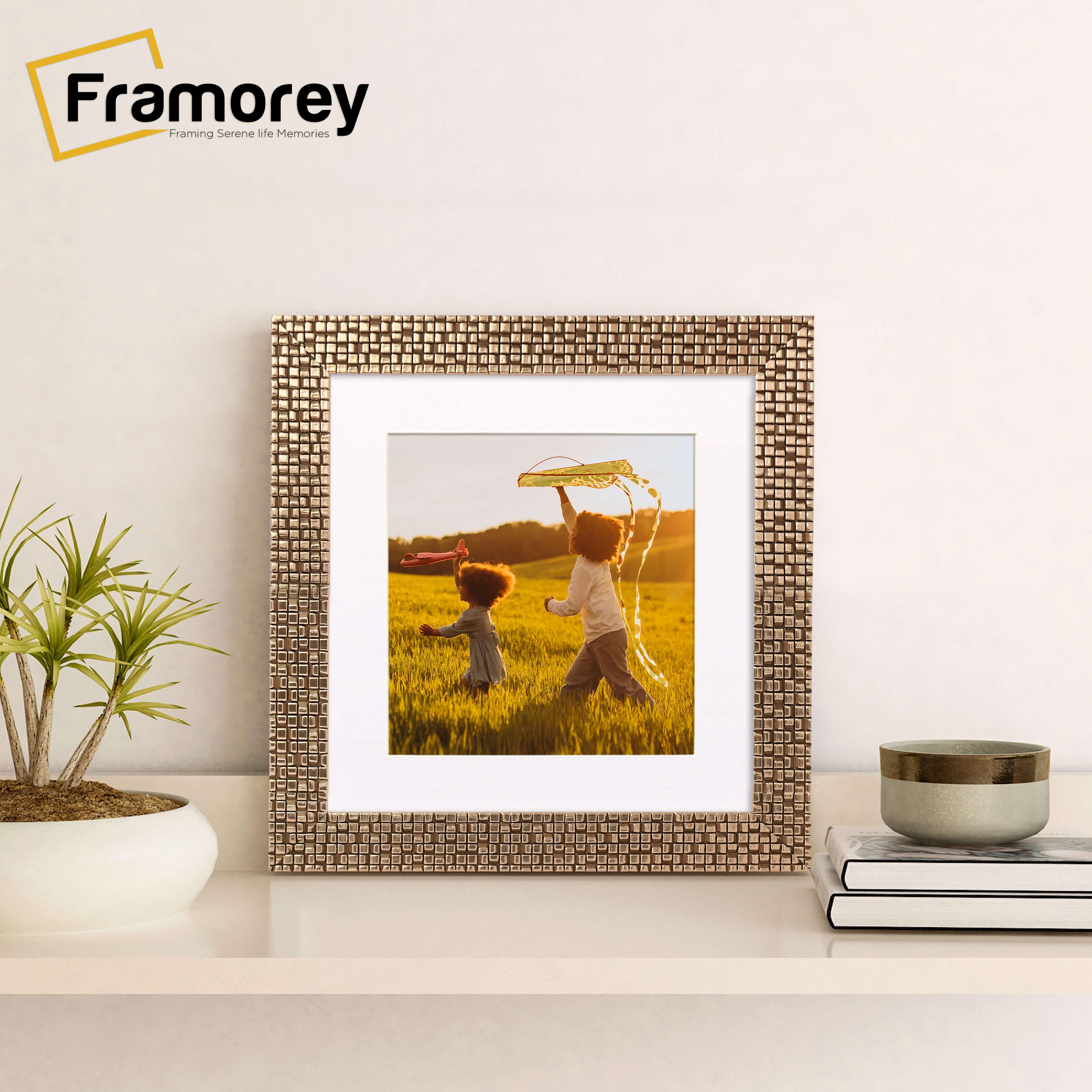 Square Picture Frame With White Mount on a wooden table standing with the wall.