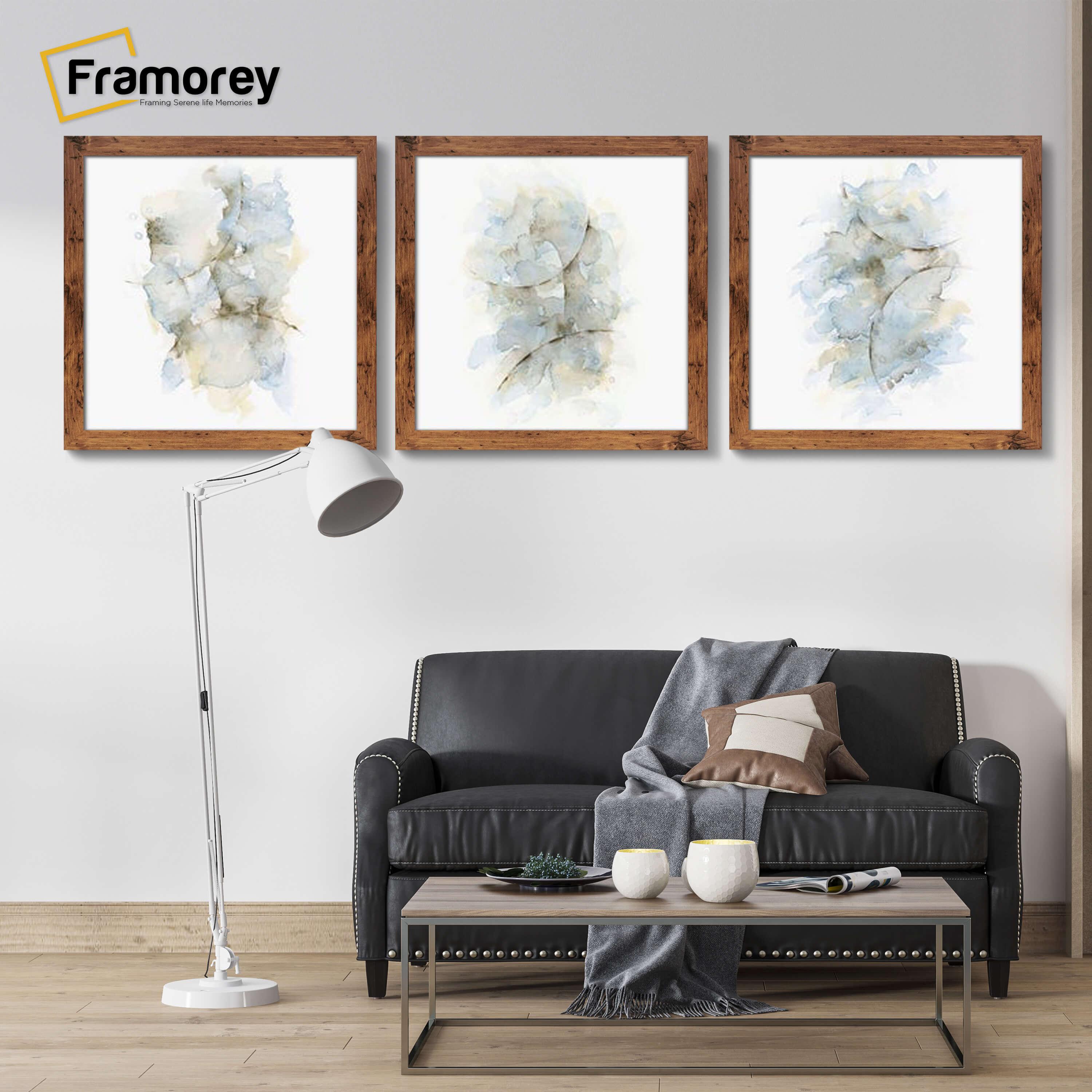 Three Square Size Rustic Oak Poster Frame hanged on a wall over a couch.