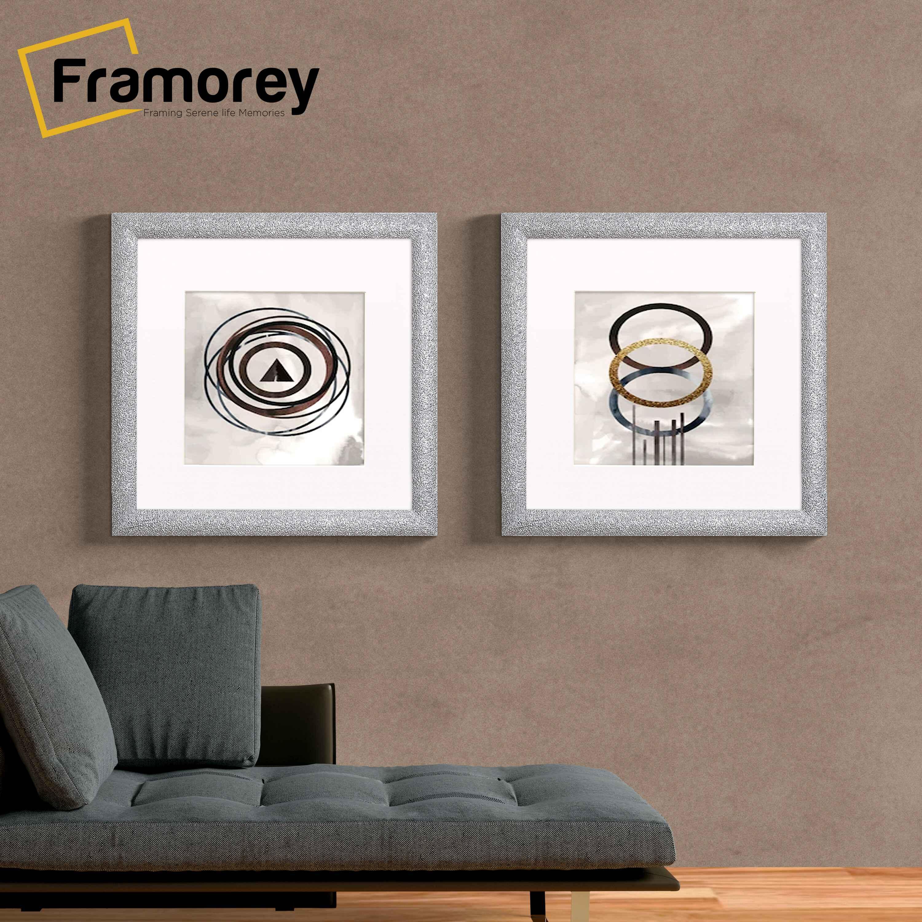 Two Square Silver With White Mount glitter Sparkle poster frames Hanged on a wall.