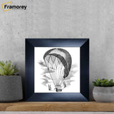 Square size Black poster frame placed on a wooden bench 