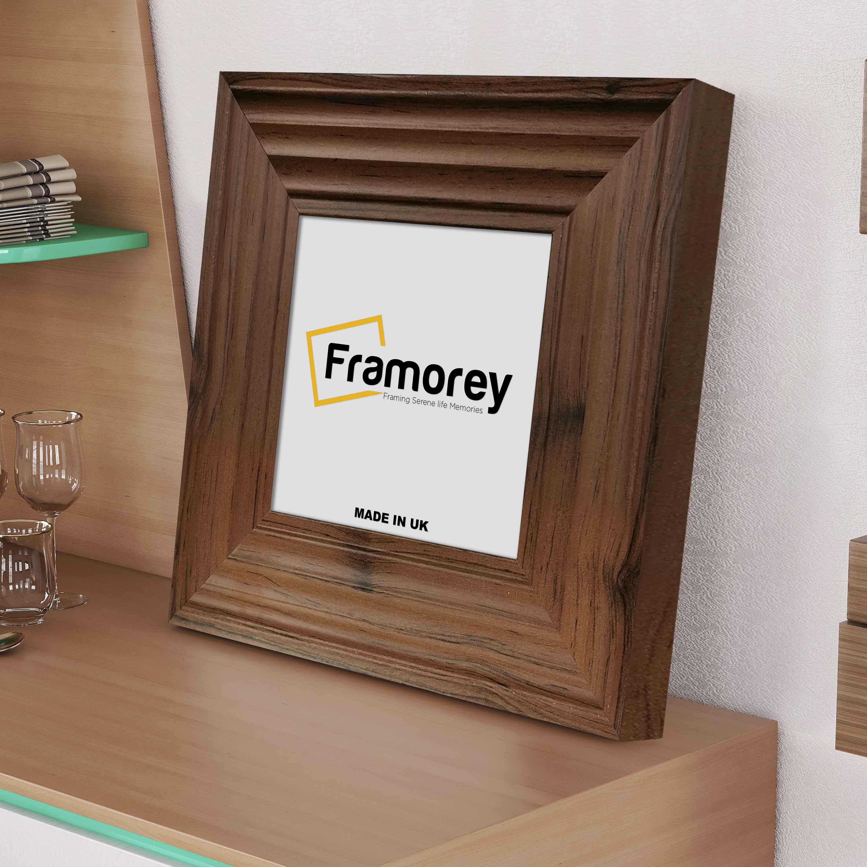 Side view of a Square Size Walnut Wooden Poster Frames Big Step Style placed on a drawer leaning with  the wall.