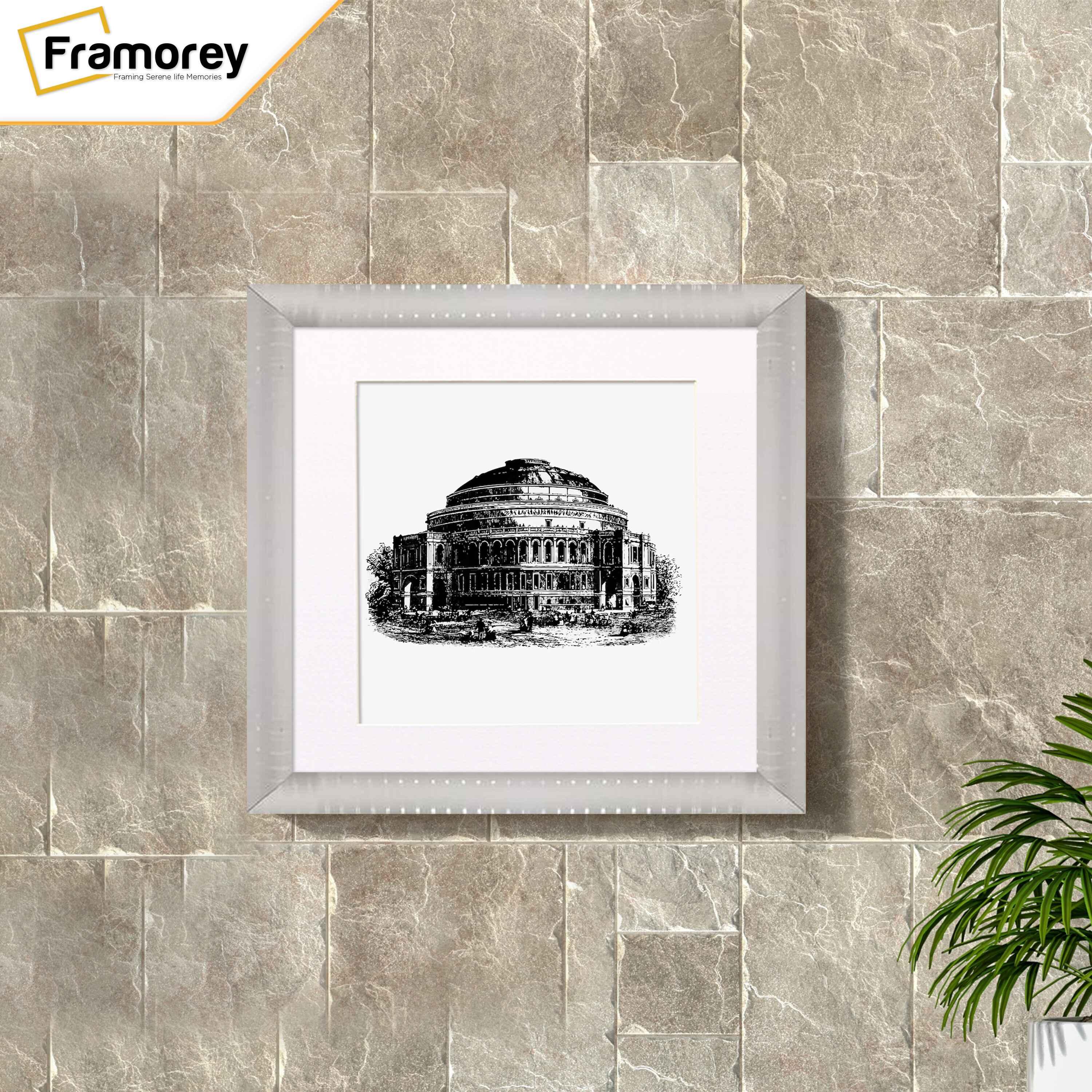 Square silver reverse style poster frame with white mount is hanging on wall