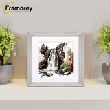 Square silver Reverse style poster frame with white mount placed on a table.