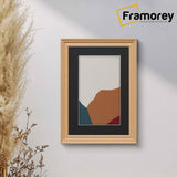 Swept Style Oak Poster Frame with black mount hanging on the wall.
