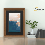 Swept Style Walnut Picture Frame With Black Mount on a floor standing with the wall.