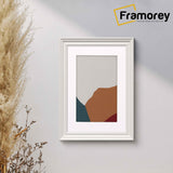 Swept Style White Poster Frame With White Mount hanging on a wall.
