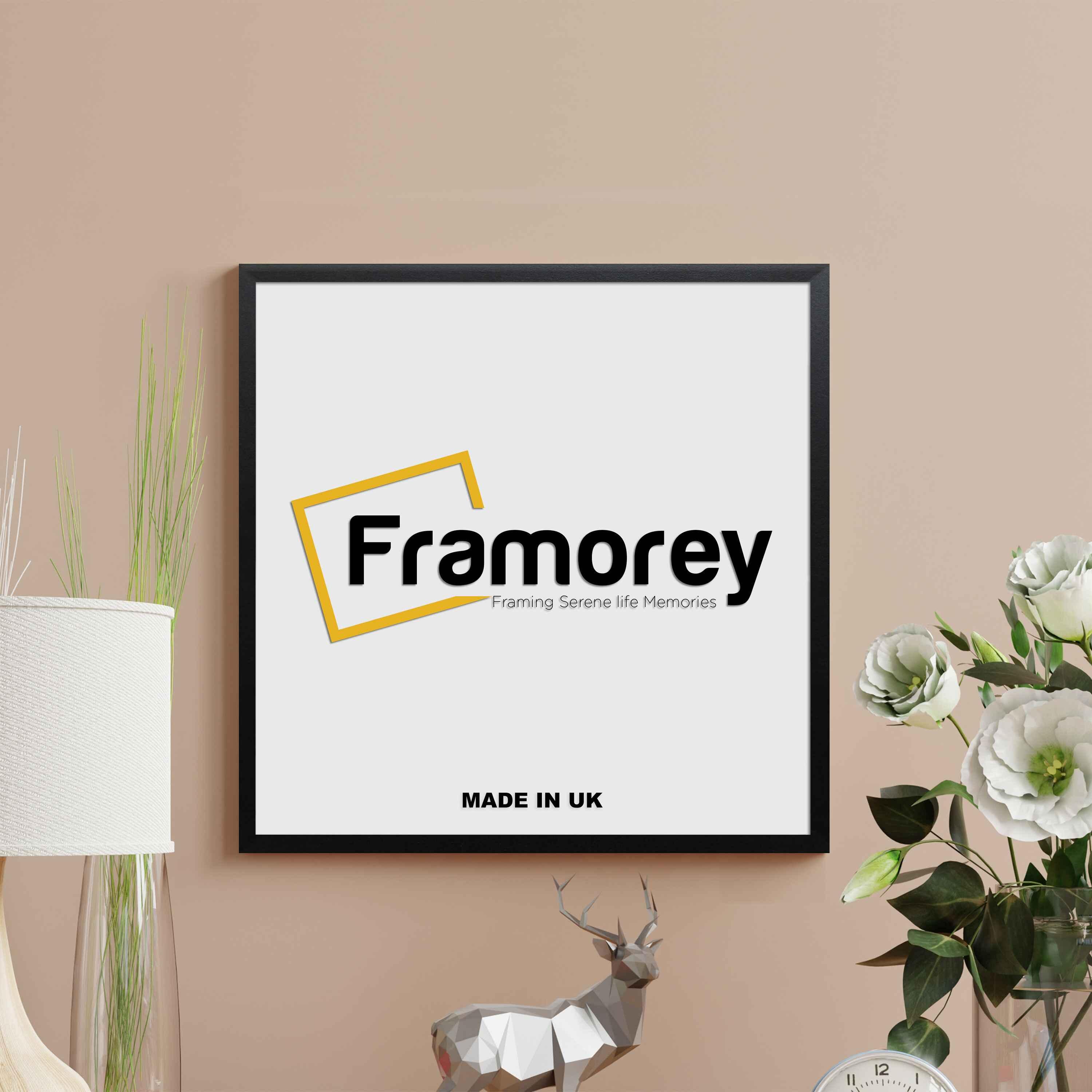 Thin sleek matt picture frame with black color hanging on a light brown wall.