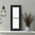 Thin Matt Panoramic Black Photo Frame With Black Mount on a wooden table leaning with the wall and two lamps just hanging on its left.