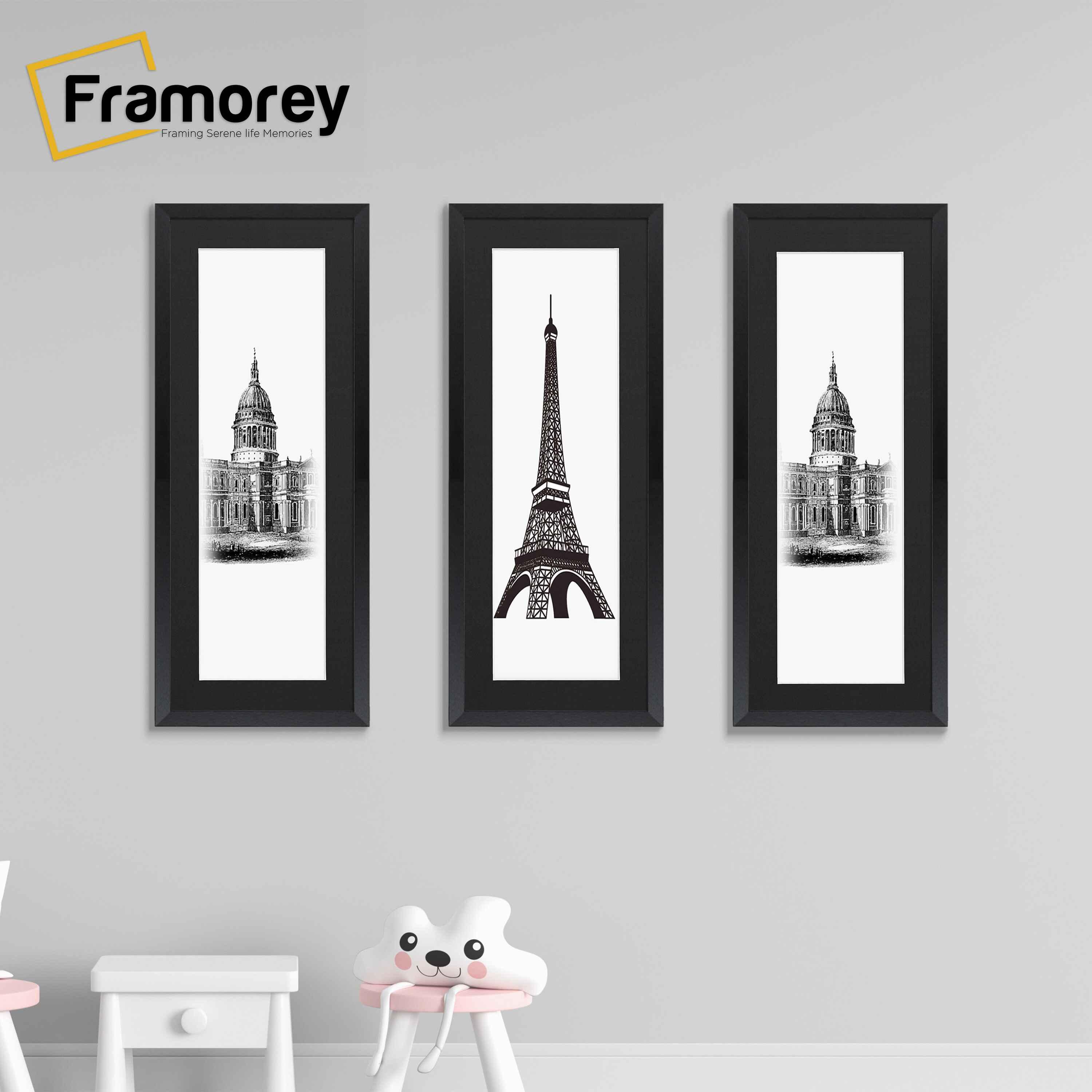 Three Thin Matt Panoramic Black Pictures Frames With Black Mount hanging on a wall with different pictures placed in them.