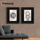 Two Glitter black poster frame with black mount hanged on a wall.