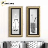 Two Panoramic Size Gold Photo Frame with black mount hanging on a wall over the couch.