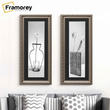 Two Panoramic Size Gun Metal Photo Frame With Black Mount hanging on a wall just over the ouch.